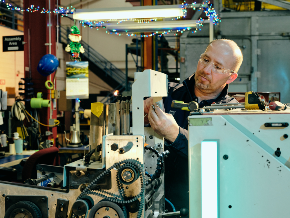 A QuadMetalworks employee assembling a product for a client
